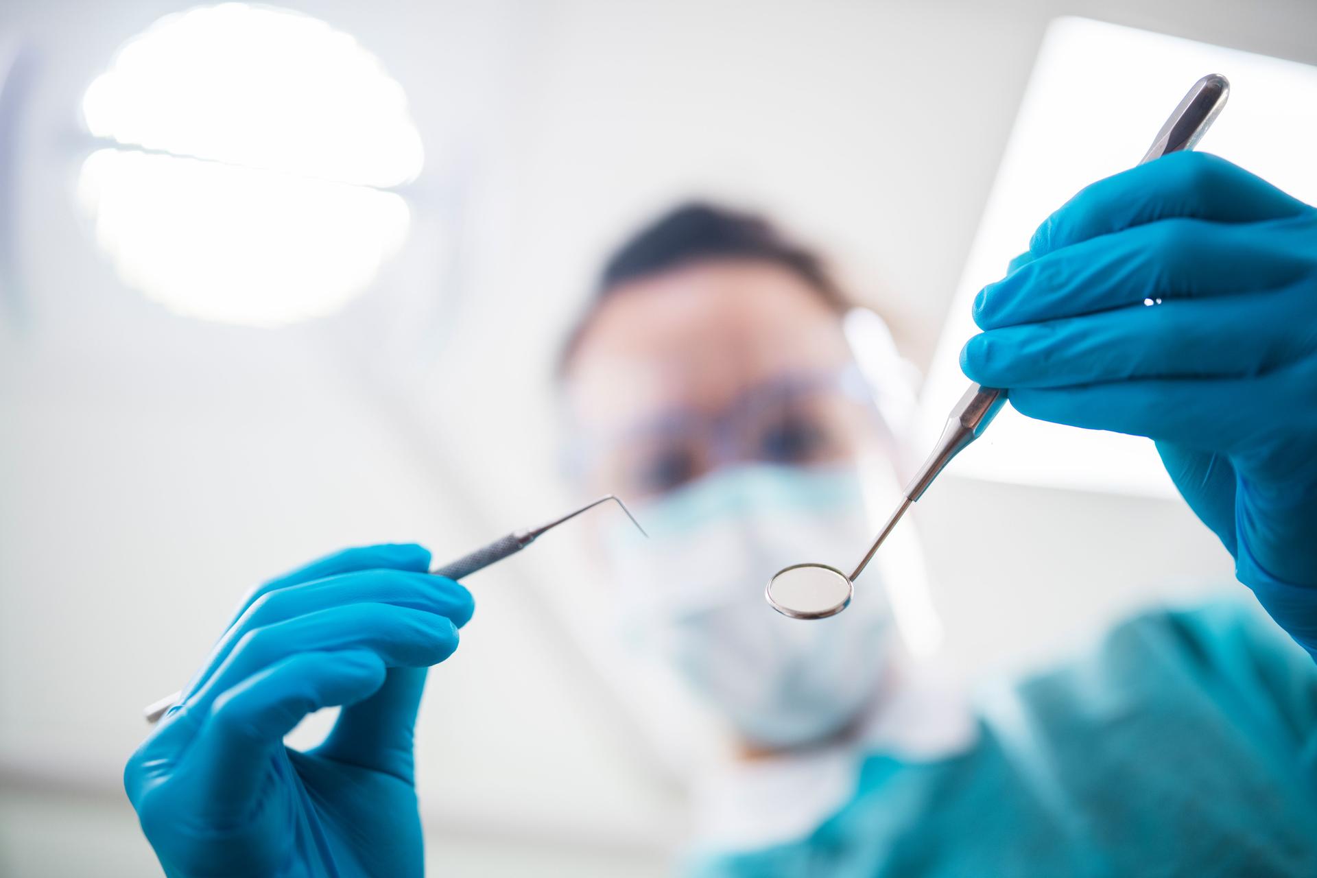 Close up of a dentist operating on a patient