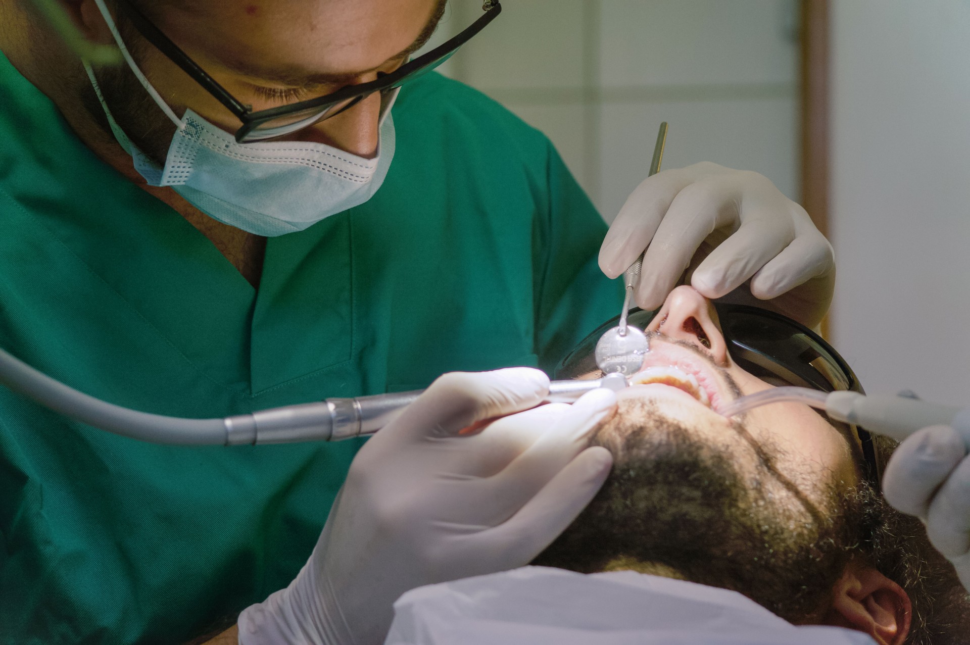 Dentist working with drill on patient mouth