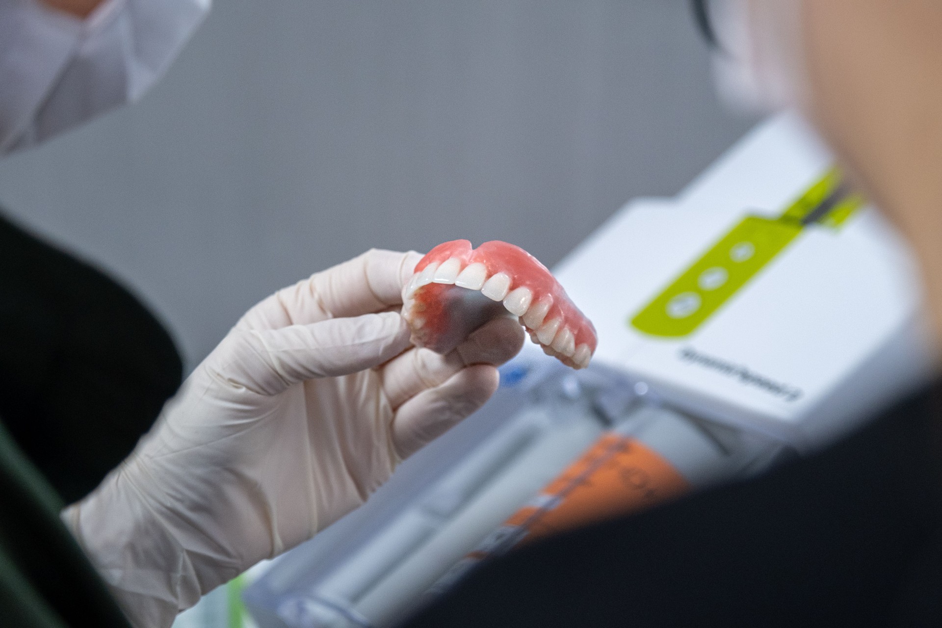 Dentist fine-tunes prosthetic upper tooth